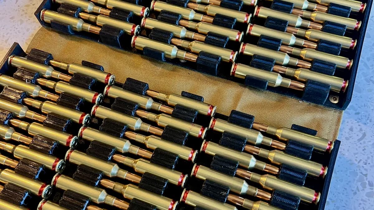 Rows of rifle ammunition staged in a field case