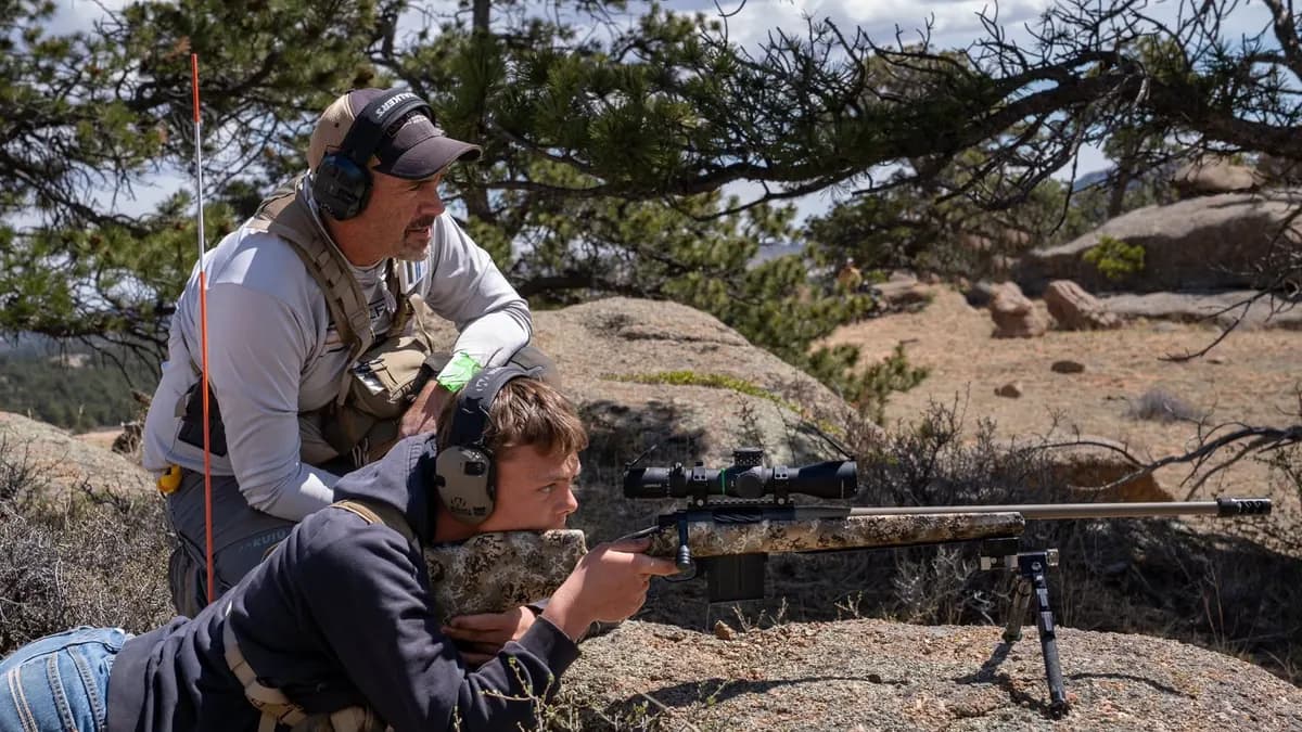 NRL Hunter competitor shooting from a field position with a rifle magazine visible