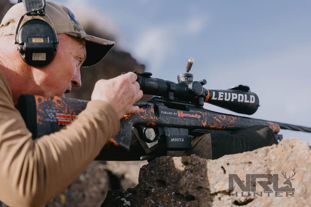 Senior NRL Hunter competitor aiming from a natural rock position