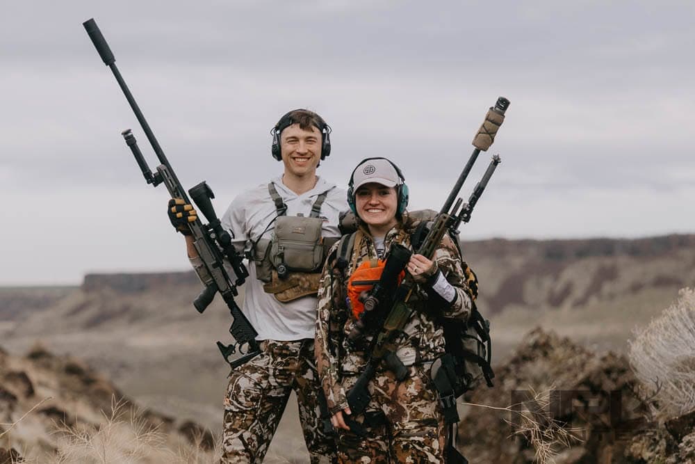 Woman NRL Hunter competitor smiling with a teammate and rifles